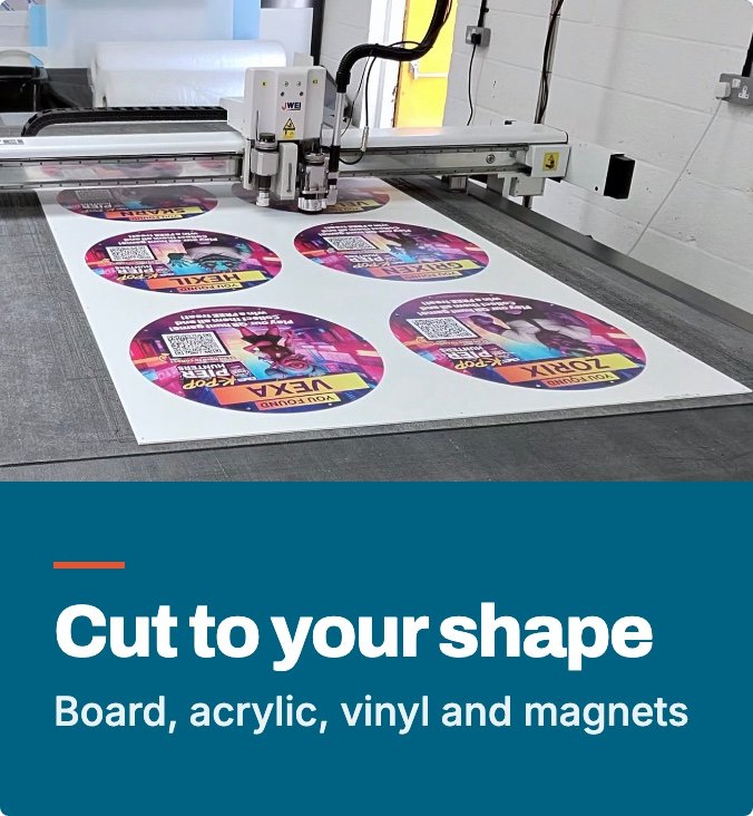 DWA cutting table cutting printed discs out of a board: custom shape cutting for board, acrylic, vinyl and magnets